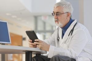 Doctor looking at his tablet