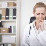 Thoughtful Female Doctor Putting Finger on Lips